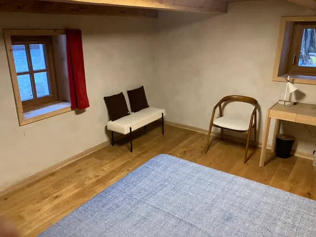 Chambre épurée avec banquette et bureau en bois