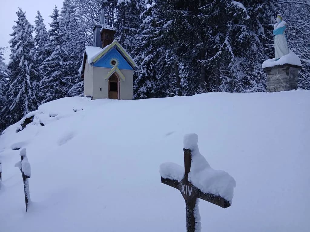 Chapelle de montagne sous la neige, sapins givrés